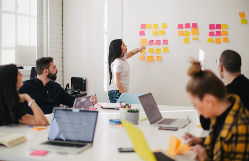 Team planning a sprint on a board of sticky notes