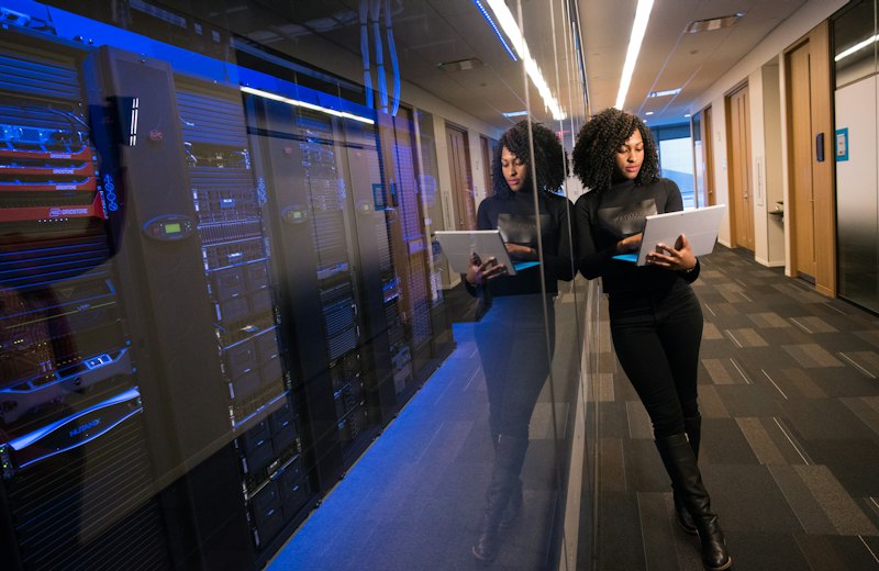 Engineer monitoring systems in a server room